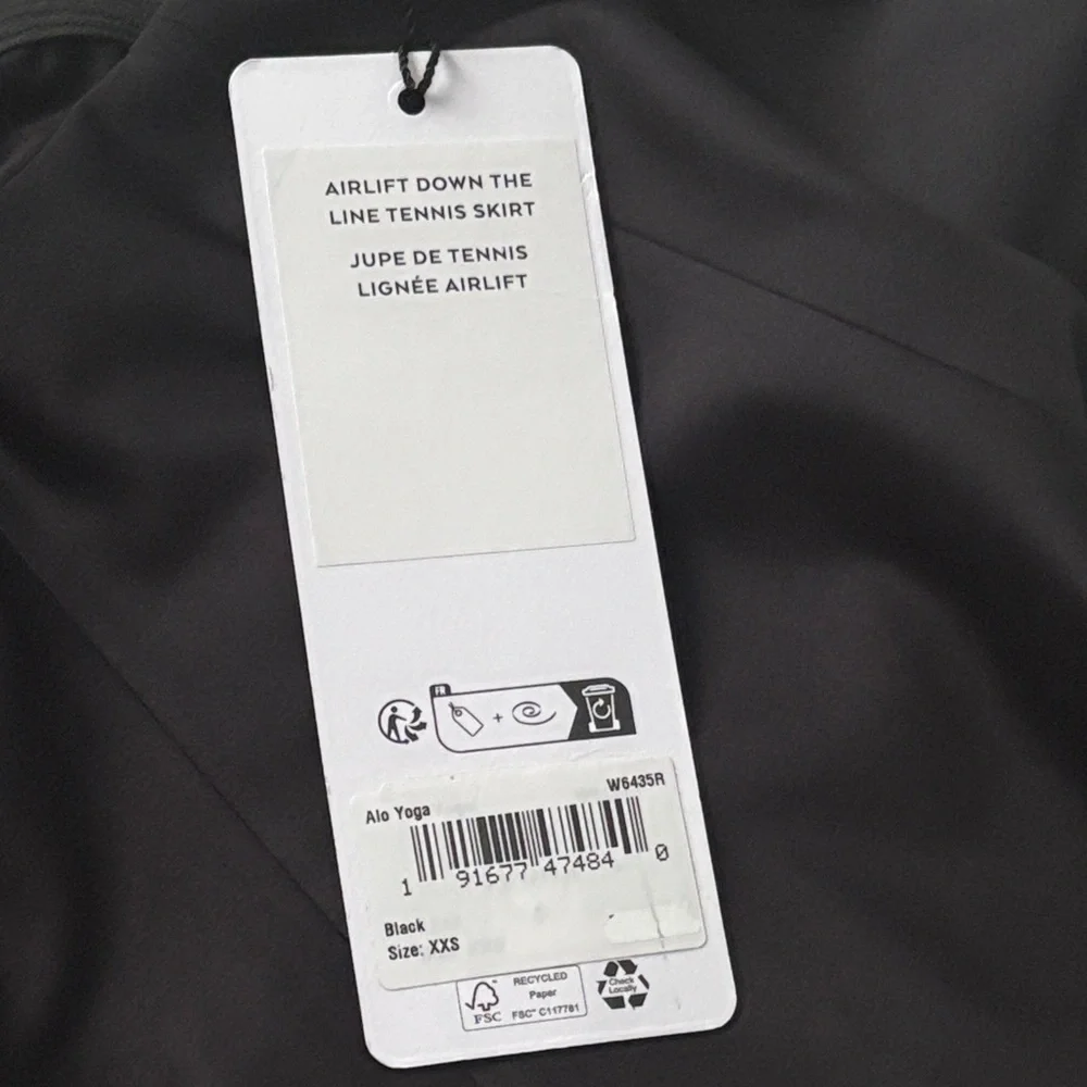 ALO Yoga Airlight Down The Line Black Mini Tennis Skirt with shorts underneath